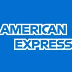 A distinctive American Express credit card (e.g., Platinum or Gold) with travel-related icons like a plane or lounge