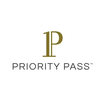 Priority Pass Airport Lounge digital card being scanned for a traveler entering a spacious, modern airport lounge