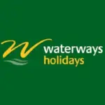 Waterways Holidays narrowboat cruising on the Grand Union Canal with a family enjoying the peaceful countryside